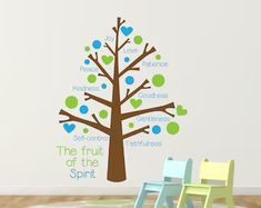 the fruit of the spirit tree wall decal is shown in blue, green and brown