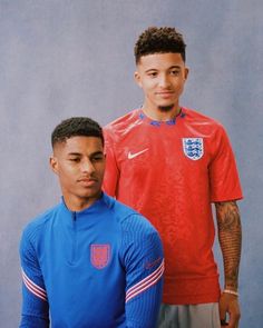 two men in red and blue soccer uniforms