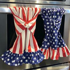 two patriotic ruffles hanging from the oven in front of an open microwave door