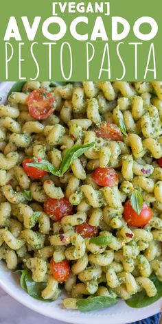 pasta with pesto and tomatoes in a white bowl