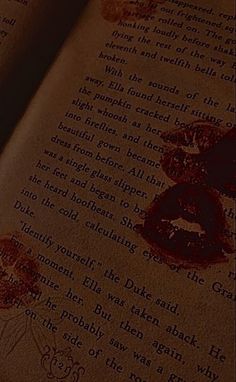 an open book with red ink on it and the pages have been altered to look like blood