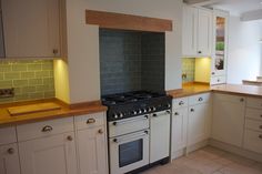 a kitchen with white cabinets and an oven