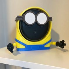 a yellow and blue toy sitting on top of a table