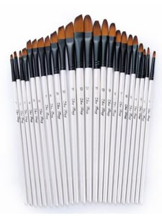 twelve brushes are lined up in a row on a white surface, with the words written below them