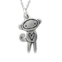 a small silver monkey with a heart on it's back end, sitting in front of a white background