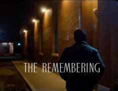 a man standing in front of a building with the words, the remembering