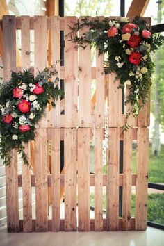 two wreaths made out of wooden pallets with flowers on them