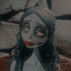 a creepy doll with long hair and makeup