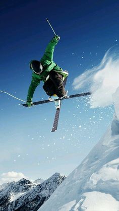 a man flying through the air while riding skis