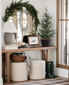 the entryway is decorated for christmas with wreaths and potted trees