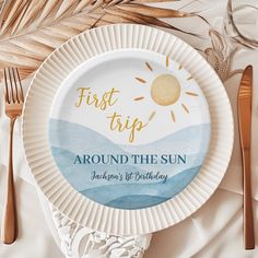 a paper plate with the words first trip around the sun on it next to utensils