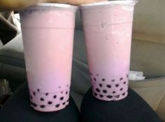 two pink cups with black polka dots on them sitting in the back seat of a car