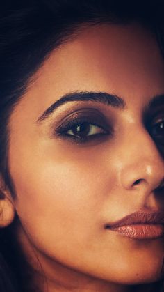 a close up of a woman's face with eyeliners on her eyes