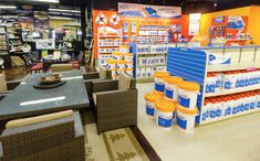 a store filled with lots of different types of products on display in front of tables and chairs