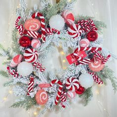 a christmas wreath with candy canes and ornaments