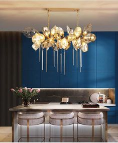 the modern chandelier is hanging over the dining room table with four stools