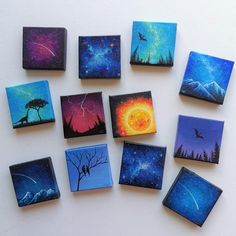 nine small square magnets with paintings of trees, birds and stars in the sky