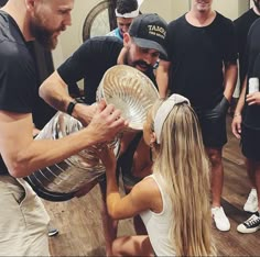 a group of people standing around each other holding a trophy