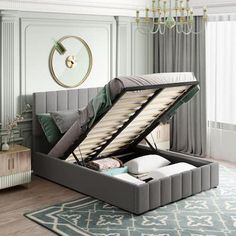 a bed that is open and sitting on a rug