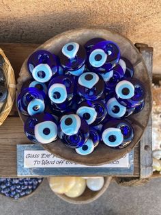 blue glass eyeballs on display in a bowl