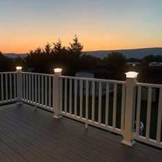 a deck with two lights on it at sunset