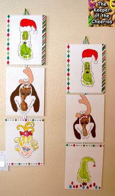 three christmas cards hanging on the wall with santa's hats and reindeers drawn on them