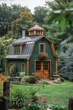 a small green house with a metal roof