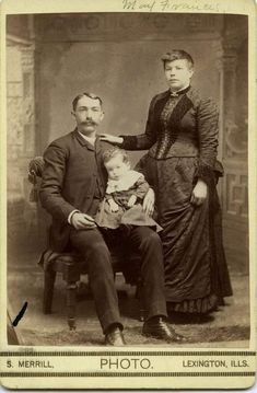 an old photo of a man and woman with a young boy sitting on a chair