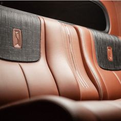 the inside of a car with brown leather and black stitching on the seat covers