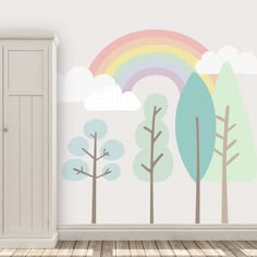 an empty room with a wall painted with trees and rainbows on the wall, next to a cabinet