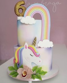 there is a cake with a unicorn on it and a number 6 on the top