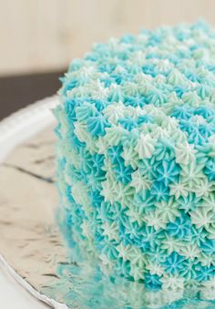 a blue and white cake sitting on top of a plate