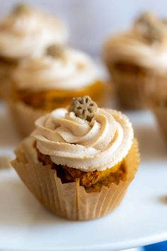 several cupcakes with frosting and sprinkles on them sitting on a plate