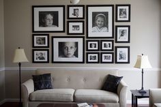 a living room filled with furniture and framed pictures on the wall above it's coffee table