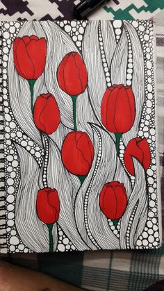 an art journal with red flowers on it