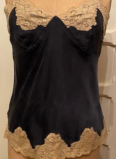 Vintage Chemise , Navy w/ beige lace trim , Silk . Prestine condition , very soft with some stretch and gold findings on bra strap Fitted V-neck Camisole With Contrast Lace, Elegant Lace Top With Built-in Bra, Chic Fitted Camisole With Delicate Lace, Chic Fitted Camisole With Contrast Lace, Fitted Lace Trim Spaghetti Strap Lace Top, Fitted Lace Bodice Cami Top, Elegant Sleeveless Tops With Contrast Lace, Elegant Sleeveless Camisole With Contrast Lace, Chic Fitted Lace Bodice Camisole