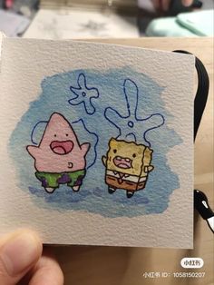 someone is holding up a card with an image of spongebob and patrick