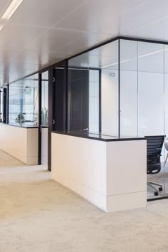 an empty office with white walls and black accents