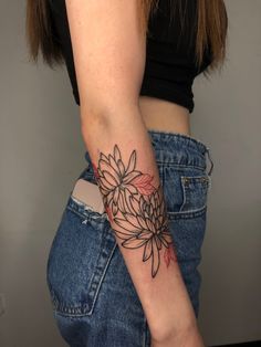 a woman with a flower tattoo on her arm