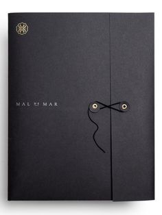 an open black book with the words mal de mar written in gold on it's cover