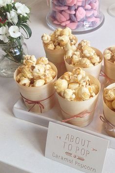 there are many small cups that have popcorn in them