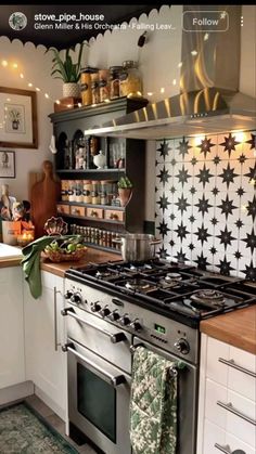 a stove top oven sitting inside of a kitchen next to a wall mounted pot rack