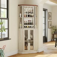 a corner cabinet with bottles and glasses on it in the middle of a living room