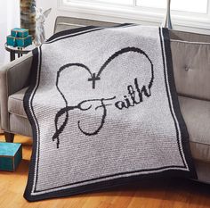 a crocheted blanket with the word faith written on it in black and white