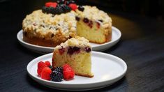 two white plates topped with cakes and berries