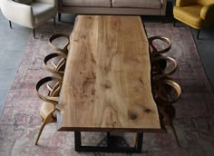 a wooden table sitting in the middle of a living room next to two couches