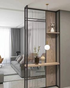 a living room filled with furniture next to a wall mounted book shelf on top of a hard wood floor