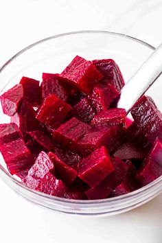 chopped beets in a glass bowl with a spoon