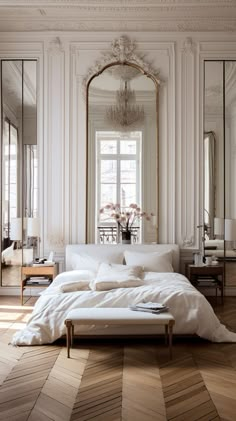 a large bed sitting inside of a bedroom on top of a hard wood floored floor