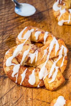 cinnamon buns with icing on a wooden table